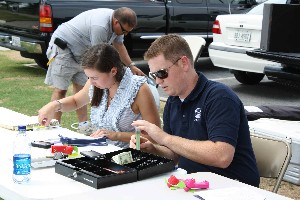 Young AFCEANs Paige DeCaro (l) and Eric Hall work the check-in station during the recruitment event at Turner Field in July.